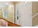 Bright foyer featuring a white door with glass panels and hardwood floors, offering a warm and inviting entry at 1250 W 141St St, Carmel, IN 46032