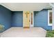 Inviting front porch with a yellow door and well maintained greenery at 1250 W 141St St, Carmel, IN 46032