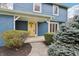 Welcoming entrance featuring a bright yellow door and a covered porch, adding charm and character to the home at 1250 W 141St St, Carmel, IN 46032