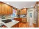Well-lit kitchen with wood cabinets, granite countertops, and stainless steel appliances, perfect for cooking enthusiasts at 1250 W 141St St, Carmel, IN 46032