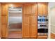 Gourmet kitchen offers stainless steel Viking refrigerator, built in ovens, and ample wood cabinetry at 1250 W 141St St, Carmel, IN 46032