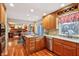 Bright kitchen featuring wood cabinets, granite countertops, and stainless steel appliances, open to living space with wood floor at 1250 W 141St St, Carmel, IN 46032