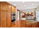 Bright kitchen features stainless steel appliances, granite countertops, wood cabinets and hardwood floors at 1250 W 141St St, Carmel, IN 46032