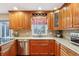 Well-lit kitchen features wood cabinetry, granite countertops, stainless steel appliances, and a kitchen window at 1250 W 141St St, Carmel, IN 46032