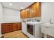 Laundry room features new washer and dryer, utility sink, and cabinets for storage at 1250 W 141St St, Carmel, IN 46032