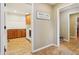 Hallway leading to the laundry room, equipped with modern appliances and ample cabinet space at 1250 W 141St St, Carmel, IN 46032