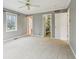 Large main bedroom featuring neutral carpet, ceiling fan, two windows and multiple doors leading to different rooms at 1250 W 141St St, Carmel, IN 46032
