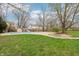 Covered in-ground swimming pool and pool area, surrounded by mature trees and a grassy yard at 1250 W 141St St, Carmel, IN 46032