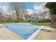 Backyard view of a covered pool with a diving board, next to a blue two story home with a large yard at 1250 W 141St St, Carmel, IN 46032