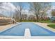 A partially covered in-ground swimming pool with a slide, set in a yard with mature trees and landscaping at 1250 W 141St St, Carmel, IN 46032