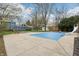 A partially covered in-ground swimming pool with slide, surrounded by the house and mature trees at 1250 W 141St St, Carmel, IN 46032