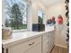 Bright walk-in closet featuring built-in drawers, ample counter space, and generous natural light from the window at 1250 W 141St St, Carmel, IN 46032