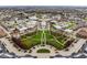 Aerial view of a town square with green space, buildings, and parking, showcasing community amenities at 12526 Pembrooke Cir, Carmel, IN 46032
