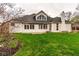 Exterior view of the home's rear facade, revealing a patio area perfect for outdoor entertaining and a spacious grassy yard at 12526 Pembrooke Cir, Carmel, IN 46032