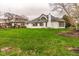 View of the house's rear exterior highlighting the well-maintained lawn and mature trees, creating a serene backyard oasis at 12526 Pembrooke Cir, Carmel, IN 46032