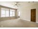 Spacious bedroom featuring large windows, neutral carpeting, and private access to the bathroom at 12526 Pembrooke Cir, Carmel, IN 46032