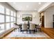 Bright dining room with a large picture window, modern lighting, and elegant decor at 12526 Pembrooke Cir, Carmel, IN 46032
