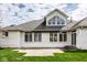 Exterior home view, featuring an awning, large windows, and beautiful landscaping at 12526 Pembrooke Cir, Carmel, IN 46032