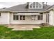 Back exterior view showcasing an awning, windows, and patio at 12526 Pembrooke Cir, Carmel, IN 46032