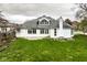 Rear exterior of a white home featuring a spacious yard, patio, and ample natural light at 12526 Pembrooke Cir, Carmel, IN 46032