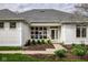 Close up of the front entrance, showcasing the window design and manicured landscaping at 12526 Pembrooke Cir, Carmel, IN 46032