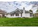 Rear exterior view showcasing the patio and lush backyard at 12526 Pembrooke Cir, Carmel, IN 46032