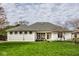 Charming single story home with tidy lawn, white siding and a cozy entryway at 12526 Pembrooke Cir, Carmel, IN 46032