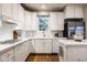 Bright kitchen with white cabinetry, tiled countertops, and stainless steel refrigerator at 12526 Pembrooke Cir, Carmel, IN 46032