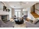 Charming living room with a fireplace, direct access to backyard, and open staircase at 12526 Pembrooke Cir, Carmel, IN 46032