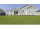 Well-maintained backyard with healthy green lawn, and views of the home's architectural details at 1499 Avondale Dr, Westfield, IN 46074