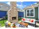 Charming backyard with a brick fireplace, patio seating, and string lights creating a cozy atmosphere at 1499 Avondale Dr, Westfield, IN 46074
