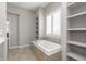 Bathroom featuring a soaking tub, tile surround, and lots of natural light at 1499 Avondale Dr, Westfield, IN 46074