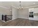 Dining area with wainscotting, modern lighting, and staircase view at 1499 Avondale Dr, Westfield, IN 46074
