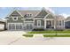 Craftsman home featuring an attached garage and covered entry on a lush green lot at 1499 Avondale Dr, Westfield, IN 46074