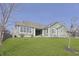 Single-story home with a well-manicured lawn, a covered porch, and tasteful landscaping at 1499 Avondale Dr, Westfield, IN 46074
