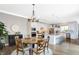 Bright, eat-in kitchen featuring white cabinetry, a center island, and a dining area with a round table at 1499 Avondale Dr, Westfield, IN 46074