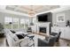 Cozy living room with a fireplace, built-in cabinets, large windows, and comfortable seating at 1499 Avondale Dr, Westfield, IN 46074