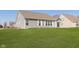 Home exterior with a large, well-manicured backyard and gray vinyl siding at 1590 Blackthorne N Trl, Plainfield, IN 46168