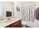 Clean bathroom featuring a shower with a black and white curtain and a vanity at 1590 Blackthorne N Trl, Plainfield, IN 46168