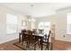 Bright dining room featuring a wood table, chandelier, and sliding door to the backyard at 1590 Blackthorne N Trl, Plainfield, IN 46168
