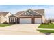 Well maintained single Gathering home with a brick facade, an attached 3 car garage, and a wide concrete driveway at 1590 Blackthorne N Trl, Plainfield, IN 46168