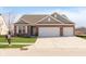 Charming single Gathering home featuring a brick facade, an attached 3 car garage, and a wide concrete driveway at 1590 Blackthorne N Trl, Plainfield, IN 46168