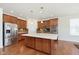 Modern kitchen boasting stainless steel appliances, a center island with pendant lighting, and wood floors at 1590 Blackthorne N Trl, Plainfield, IN 46168
