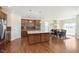 Open concept kitchen featuring an island, wood floors, stainless steel appliances, and dining area at 1590 Blackthorne N Trl, Plainfield, IN 46168