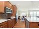 Well-equipped kitchen showcasing granite counters, stainless steel appliances, and a dining area beyond at 1590 Blackthorne N Trl, Plainfield, IN 46168