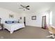 Spacious main bedroom with a ceiling fan, carpet flooring, and a comfortable queen-sized bed at 1590 Blackthorne N Trl, Plainfield, IN 46168
