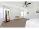 Bright main bedroom with a ceiling fan, carpet flooring, desk, and full-length mirror at 1590 Blackthorne N Trl, Plainfield, IN 46168