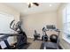 Home workout room with various exercise machines, carpet flooring, and a ceiling fan at 1590 Blackthorne N Trl, Plainfield, IN 46168