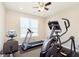 Home workout room with treadmill, elliptical machine, and ceiling fan at 1590 Blackthorne N Trl, Plainfield, IN 46168