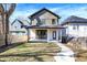 The backyard showcases a well-maintained lawn, a modern home, and a quaint outdoor seating area at 1603 Nowland Ave, Indianapolis, IN 46201